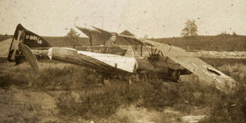 A Canadian soldier examines the wreckage of a German plane somewhere at the front circa 1916–1918.