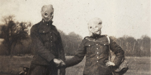A pair of Canadian soldiers try on their regulation respirators. These masks provided protection against chemical weapons such as chlorine and mustard gasses that terrorized troops at the front.
