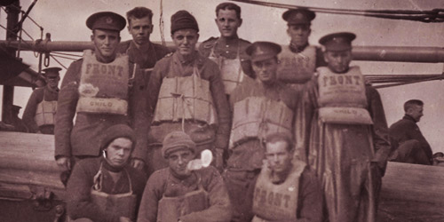 A group of Canadian soldiers wear life preservers aboard a Canadian troop ship bound for England circa 1915–1918.